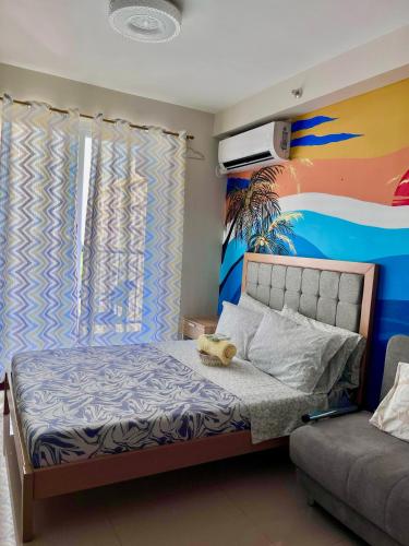 a bedroom with a bed with a teddy bear on it at Saekyung Condominium in Suba