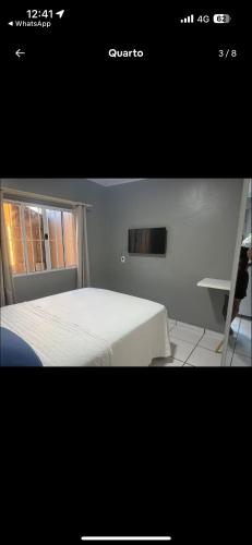 a picture of a bedroom with a bed and a window at Apartmento-Studio in União da Vitória