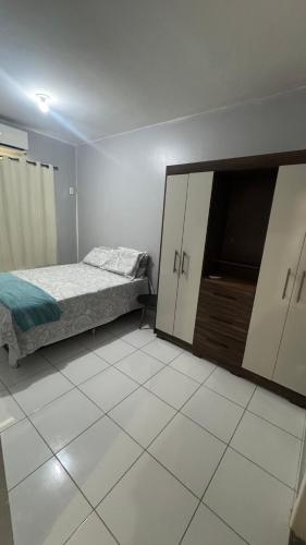 a bedroom with two beds and a dresser in it at Apartamento mobiliado in Marabá