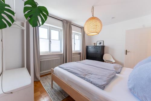 a bedroom with a bed and a chair and a window at Ferienwohnung Aribo in Seeon-Seebruck