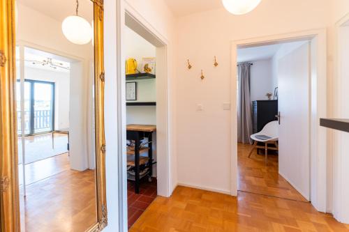 a hallway with a mirror and a table in a room at Ferienwohnung Aribo in Seeon-Seebruck