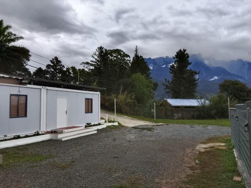 a white building sitting on the side of a road at K2K Studio Homestay in Ranau