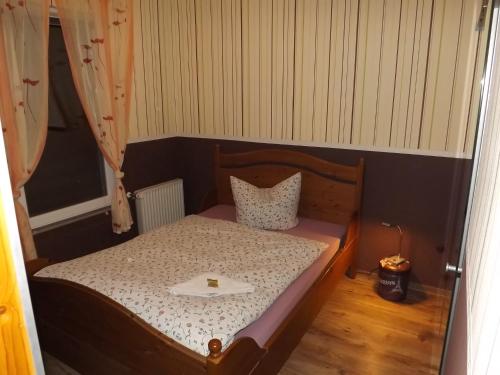 a small bedroom with a bed with a tray on it at Haus Oberkassel in Bonn