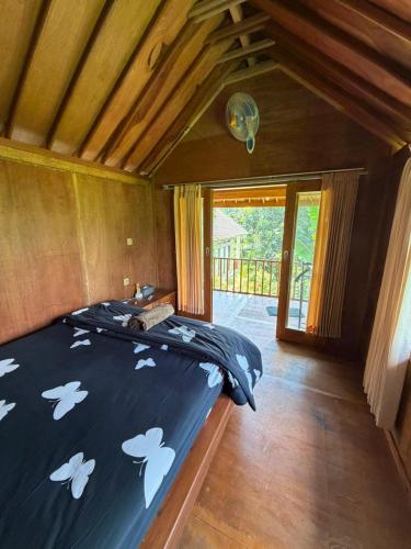 a bedroom with a bed with white birds on it at Lombok Riverside Bungalows in Masbagik