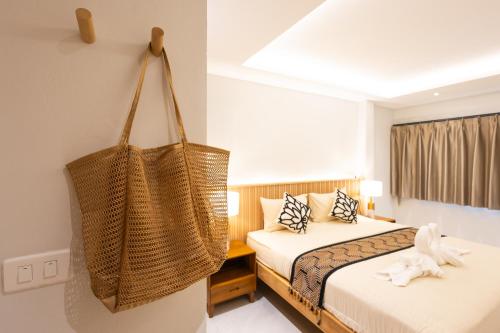 a hotel room with two beds and a hanging basket at Bang Po Hut Nature - Lush Garden & Natural View in Ban Bang Po