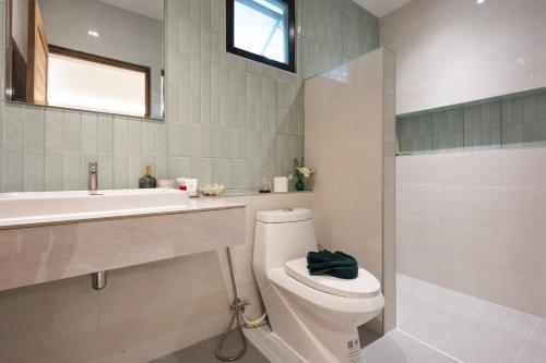 a bathroom with a toilet and a sink and a shower at Bang Po Hut Nature - Lush Garden & Natural View in Ban Bang Po
