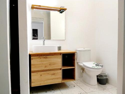 a bathroom with a sink and a toilet at Kaza LYBS in Fort-de-France