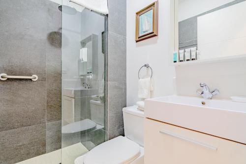 a bathroom with a shower and a toilet and a sink at Aruba Life 315 in Noord