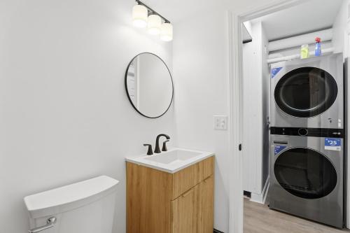 a bathroom with a sink and a washer and dryer at Keifer Suite in Detroit