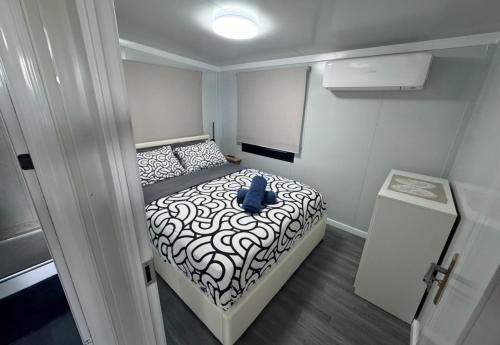 a small bedroom with a bed in a small room at Country Tracks in Willowbank