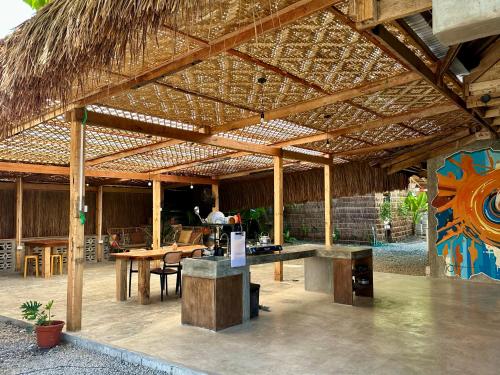 a large wooden pavilion with a table and chairs at LAWI Haven Homestay with Dorm in Burgos