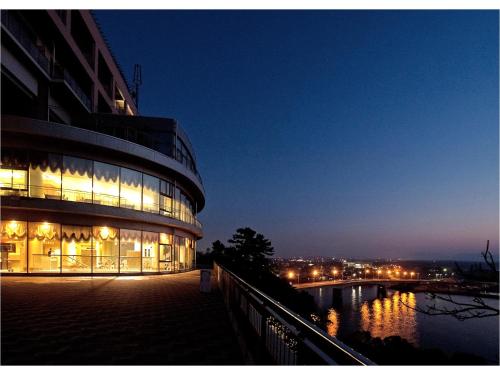 a building at night with the lights on at Kokumin Shukusha Marine Terrace Ashiya in Kitakyushu