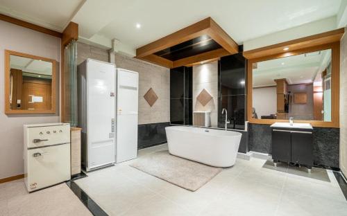 a large bathroom with a tub and a sink at Nowon Luxe in Seoul