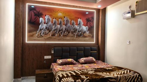 a bedroom with a bed with a painting on the wall at Hotel SR & restaurant in Bhauvāpār