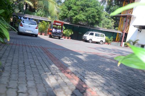 a cobblestone street with two cars parked on it at Cochin Palace in Cochin