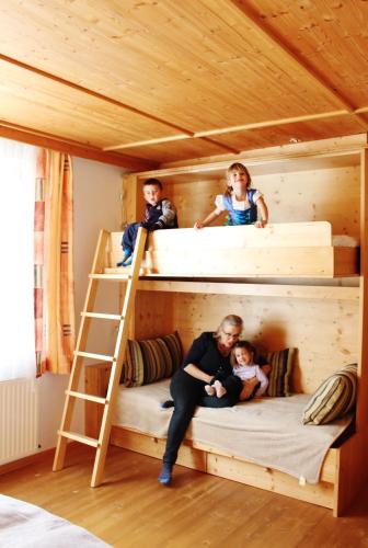 a man and three children sitting in a bunk bed at Da Bräuhauser in Stadl an der Mur