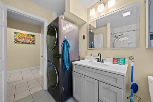 a bathroom with a sink and a washing machine at The Public Street Residence in Providence