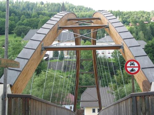 a large wooden bridge with a sign on it at Da Bräuhauser in Stadl an der Mur