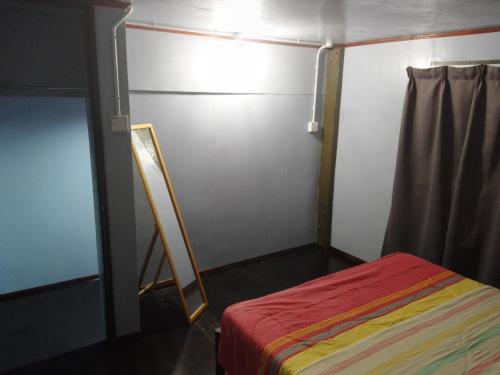 a small room with a bed and a mirror at Ren-Hana Kundasang in Kundasang