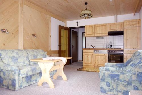 a kitchen with a couch and a table in a room at Ferienhaus Tirolerhof in Kals am Großglockner