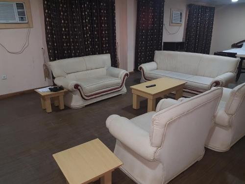 a living room with couches and chairs and tables at Citilodge Hotel & Conference Centre Newly Renovated in Abuja