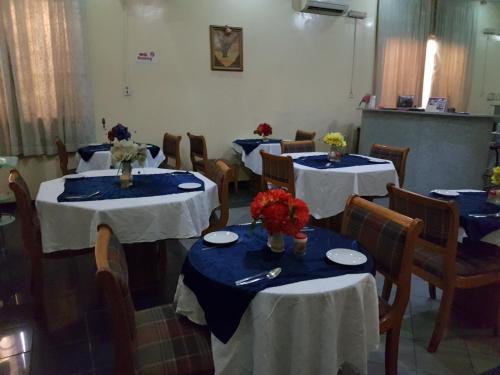 a room with tables and chairs with blue and white linens at Citilodge Hotel & Conference Centre Newly Renovated in Abuja