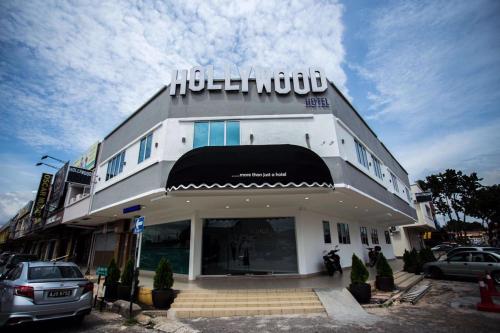 a building with a car parked in front of it at Hollywood Hotel in Ipoh