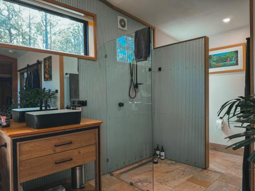 a bathroom with a shower and a sink at The Little Seed in Franklin