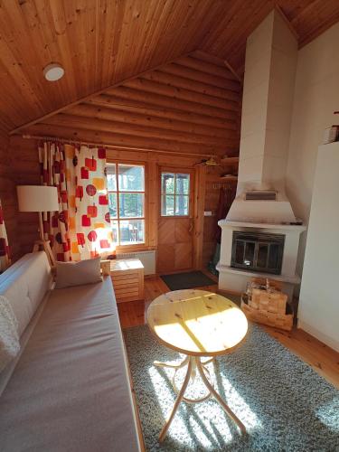 a living room with a table and a stove at Kotikolo in Inari