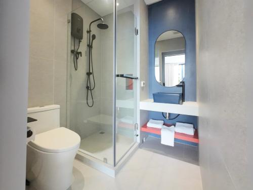 a bathroom with a toilet and a sink and a mirror at TERREST MAISON On Nut in Bangkok