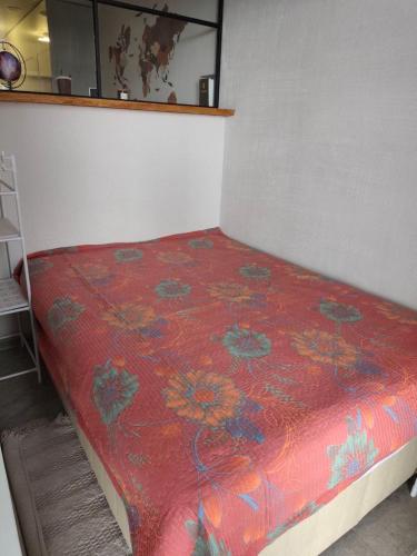 a bed in a room with a red comforter at Batumi View apartment in Kachretʼi
