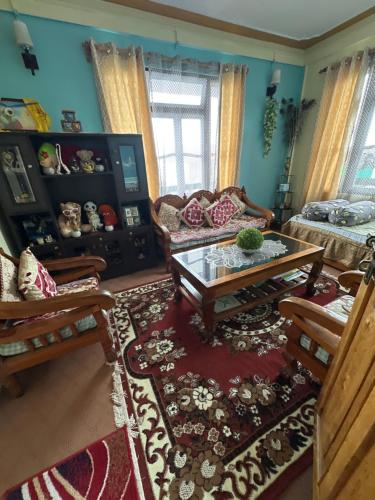 a living room with a couch and a coffee table at Y Not Sonada in Sonāda