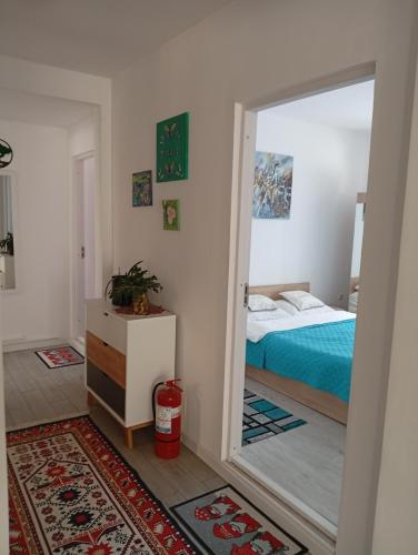 a bedroom with a bed and a door with a mirror at ASK MOUNTAIN in Buşteni