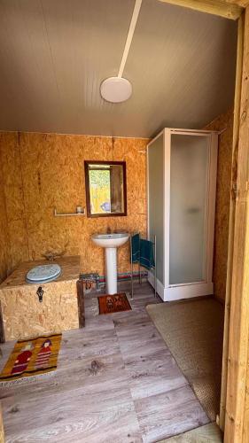 a bathroom with a sink in a room at Roulotte Providence in Boudeville