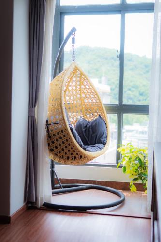 a hanging hammock in a room with a window at Hotel Sampada Boutique in Pokhara