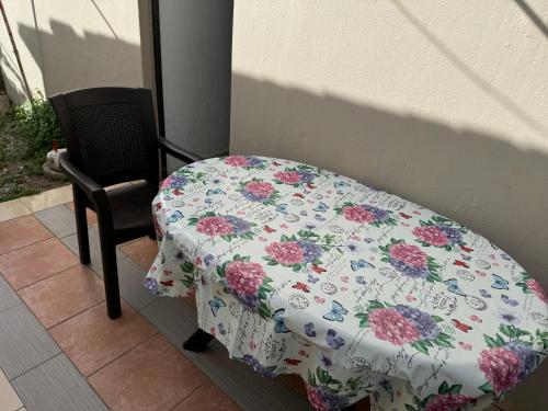 a table with a floral table cloth on a chair at Sofia Rooms in Palaiochora