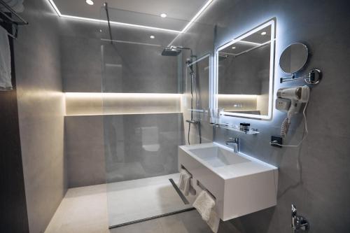 a bathroom with a white sink and a mirror at RIO Hotel in Samarkand