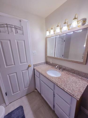 a bathroom with a sink and a mirror at Residence Tacoma in Tacoma