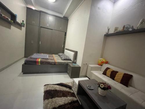 a living room with a bed and a couch at Cozy stay wsb in Wonosobo
