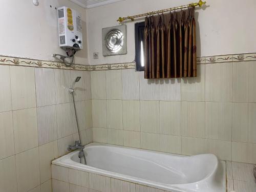 a bathroom with a bath tub in a room at Cozy stay wsb in Wonosobo