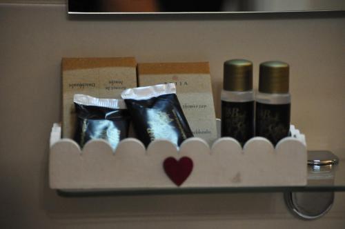 a shelf with shoes and boxes on a wall at Artisti Rooms in Ravenna