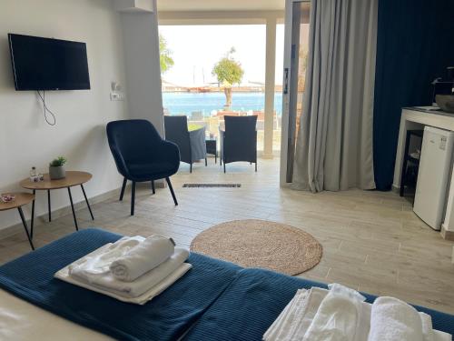 a bedroom with a bed with towels on top of it at Sea View Apts & Suites by Pachiplex in Malia