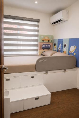 a bedroom with a bed and a window with a mattress at Nicholas Residence in Silang