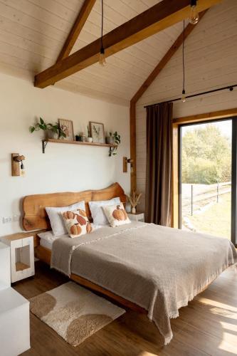 a bedroom with a bed and a large window at Lehit slavsko in Slavske