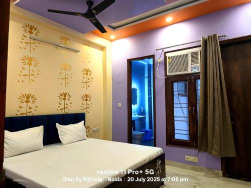 a bedroom with a bed and a window at Fng Guest House in Noida