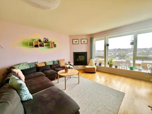 a living room with a couch and a table at Spacious apartment with amazing views in Sandnes