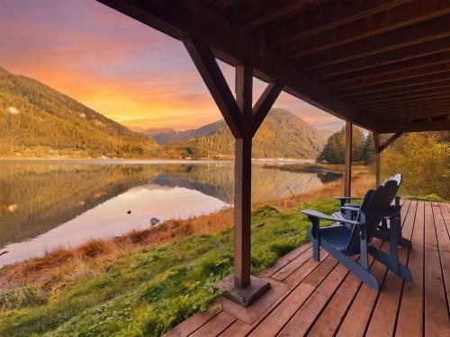 a porch with a bench and a view of a lake at Oceanfront Apartment with Sauna and Covered Deck in Juneau