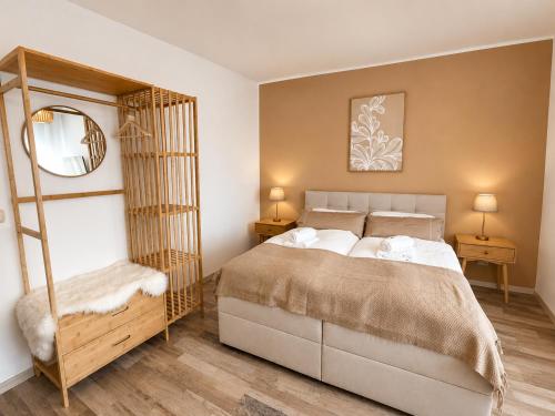 a bedroom with a large bed and a mirror at Ferienwohnung Rehn 2 in Bad Kissingen