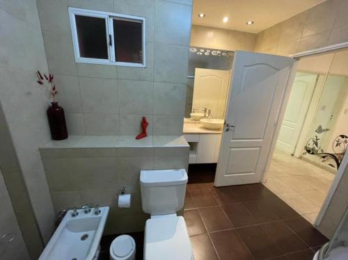 a bathroom with a toilet and a sink at Nova IVE Apart in San Luis
