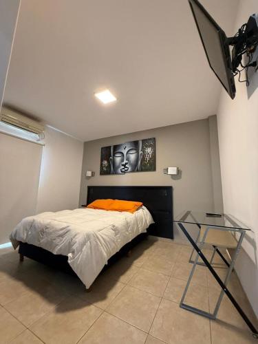 a bedroom with a bed and a glass table at Nova IVE Apart in San Luis